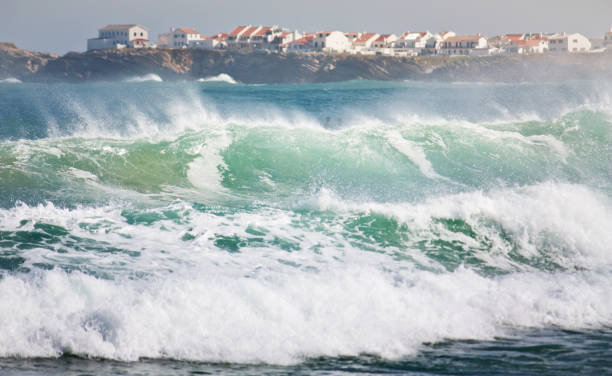 Surfer looking at a big wave breaking in front of him