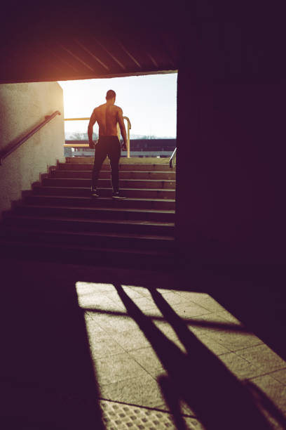 istock Muscular man on a staircase 1055651352