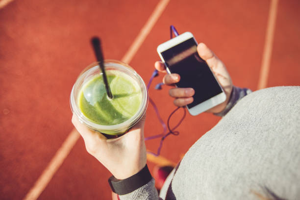 istock Woman listening to music while jogging 1055656304