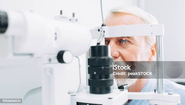 Senior Man Getting Eye Exam At Clinic Closeup Stock Photo - Download Image Now - Eye Exam, Ophthalmologist, Eye
