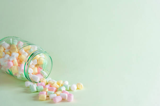 istock Spilled jar with colorful mini marshmallows 1055658566