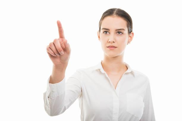 istock Young pretty bussines woman using invisible touchscreen gesture 1055658822
