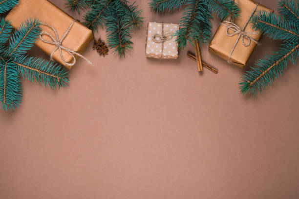 istock Christmas presents in kraft paper with pinetree branches 1055658894