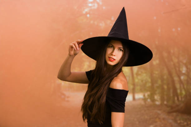 istock Halloween holiday background. Halloween Witch in a dark forest 1055659666