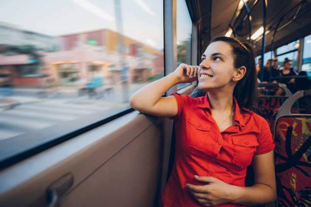 istock Young woman on a city bus ride 1055660004