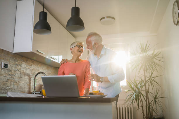 istock Lovely couple enjoying their breakfast in a sunny kitchen 1055665224