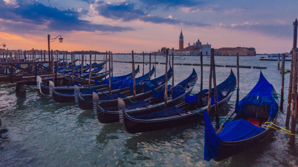 istock Gondolas at sunrise in Venice, Italy 1055667400