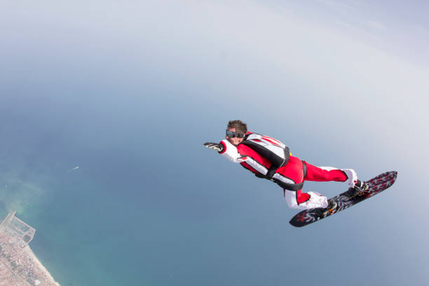 istock Skydiver on snowboard falls towards the earth 1055667908