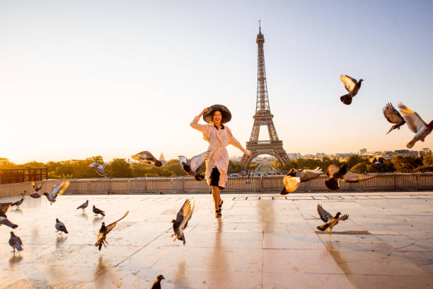 istock Woman on the square with beautiful view on the Eiffel tower in Paris 1055669736