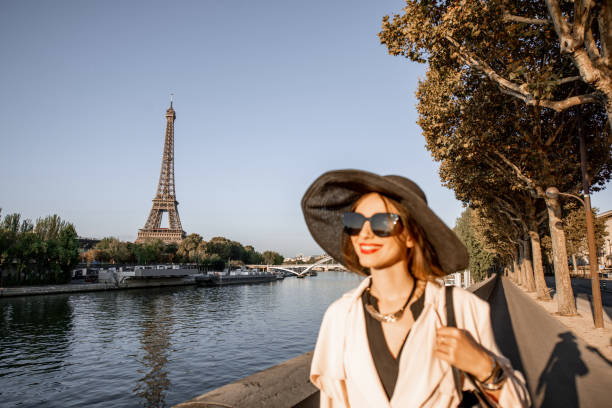 istock Woman walking in Paris with Eiffel tower on the background 1055669950