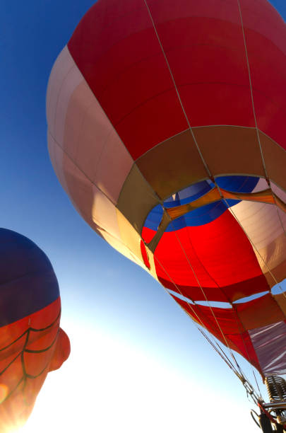 istock Hot air balloon at dawn preparing for take off 1055670236