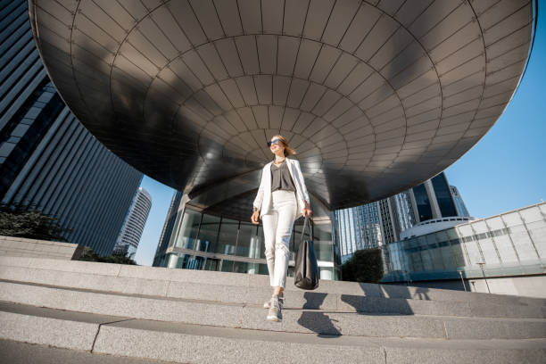 Financial district with business woman in Paris Business woman at the financial district with beautiful skyscrapers on the background during the morning light in Paris. Wide panoramic view business architecture blue people stock pictures, royalty-free photos & images