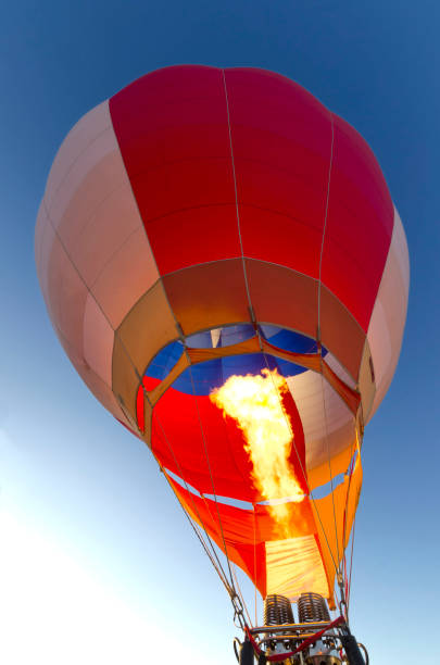 istock Hot air balloon at dawn preparing for take off 1055670580