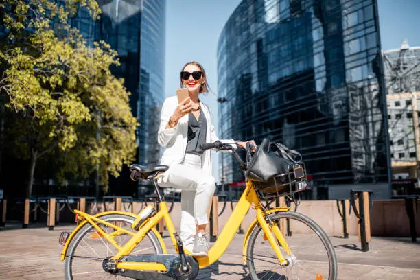 Photo of Business woman with bicycle at the financial district outdoors