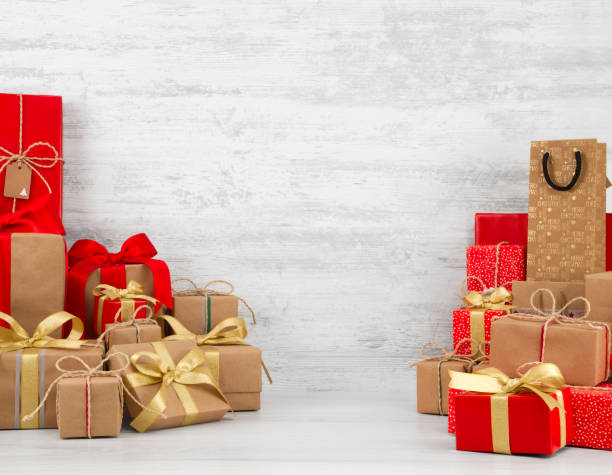 istock Christmas Gift Boxes on White Wooden Background 1055673540