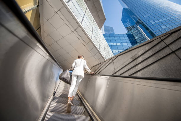 istock Modern financial district with business wwoman 1055675432