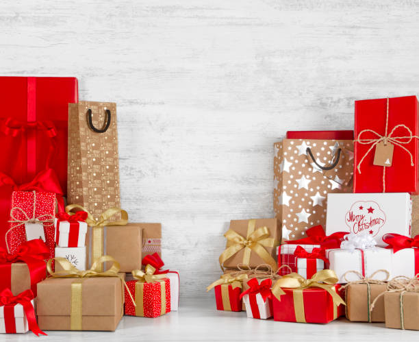 istock Christmas Gift Boxes on White Wooden Background 1055677986