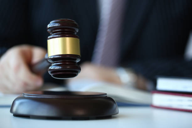 istock Judge holding hammer in hand lies 1055682838