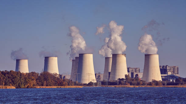istock Smoking chimneys next to a lake. 1055683552