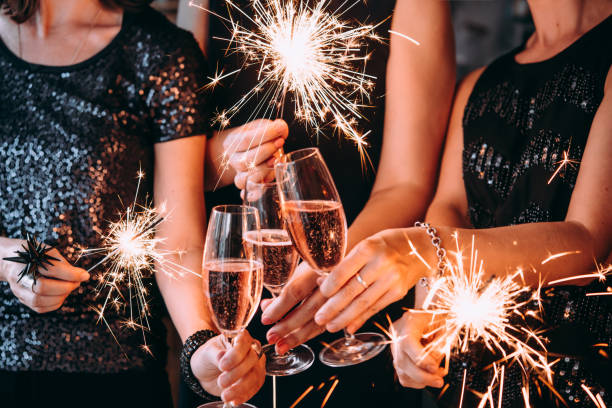 Christmas party Friends celebrating Christmas or New Year eve. champagne stock pictures, royalty-free photos & images