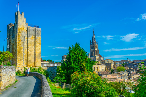 View of French village Saint Emilion dominated by spire of the monolithic church and Tour du Roy