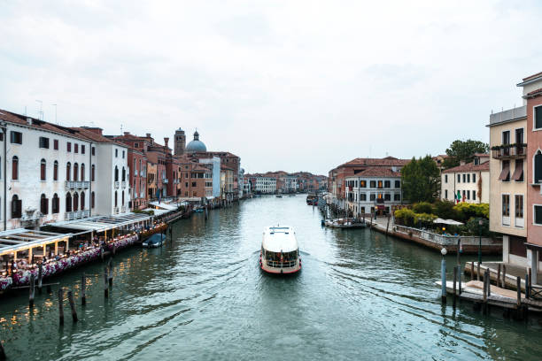 Watercolor drawing of Venice cityscape with Grand Canal waterway. View from Scalzi bridge. Gondolas, boats, yachts, vaporettos docked and sailing Canal Grande. Veneto Region, Italy.