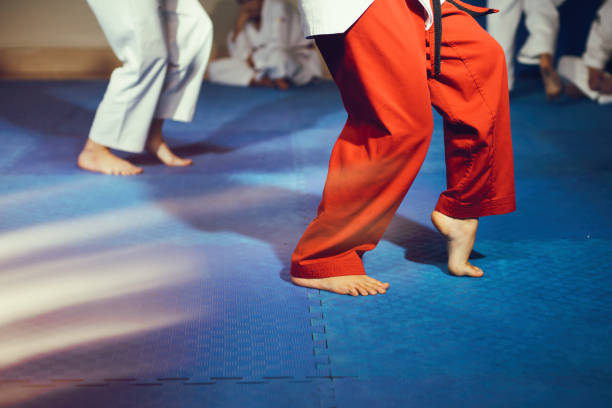 istock Taekwondo athletes bare feet martial arts movement on floor 1055688854