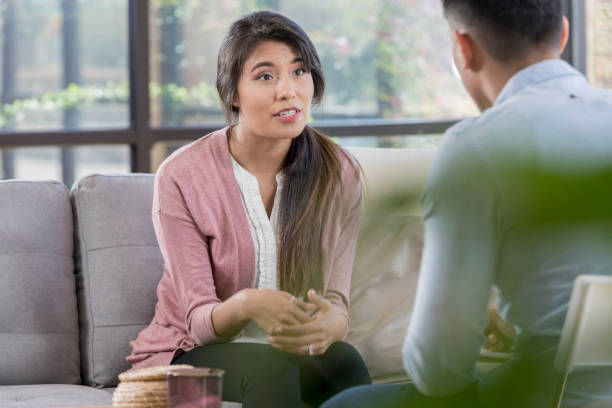 istock Young woman talks about her concerns with therapist 1055689218