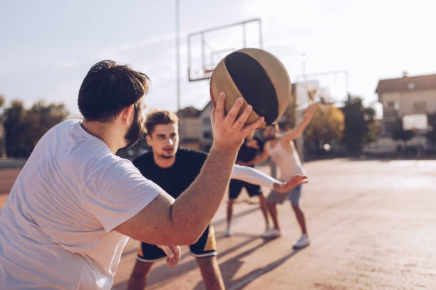istock Men playing streetball 1055689224