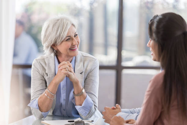 istock Cheerful financial advisor meets with clients 1055689256