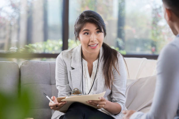 istock Counselor talks with a young male patient 1055689306
