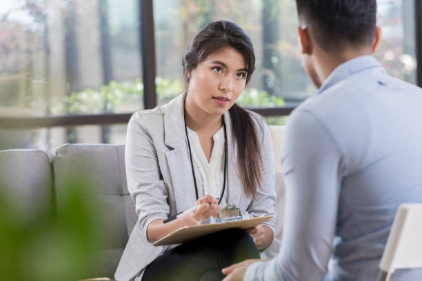 istock Attentive counselor talks with patient 1055689308