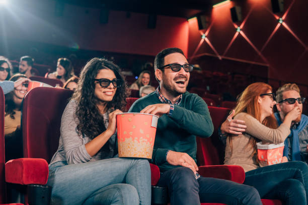 istock Couple with 3D glasses eating popcorn 1055691592