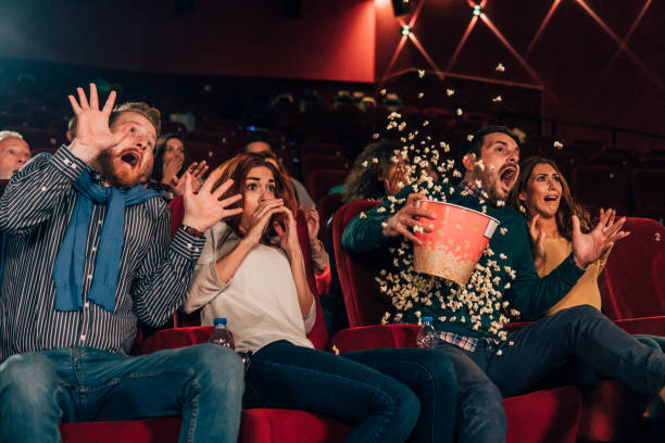 istock Scared people spilling popcorn at cinema 1055691594