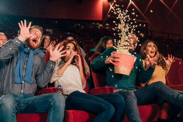 istock Terrified people spilling popcorn at cinema 1055691698