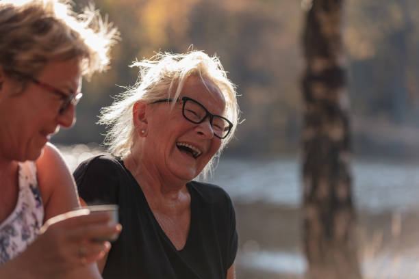 istock Senior lady drinking coffee outdoors 1055694052