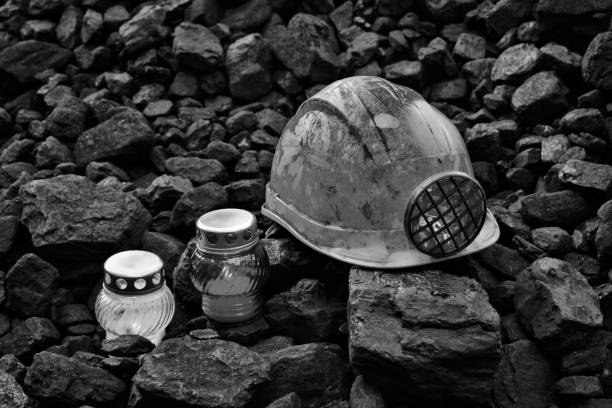 istock Vigil light, candle with mining helmet on cheap of coal 1055694104