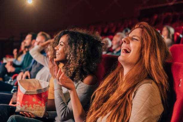 istock Woman laughing at cinema 1055695064