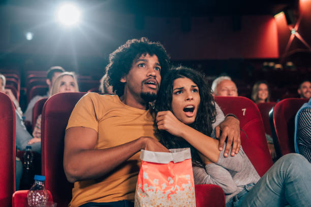 istock Terrified couple watching a movie together 1055698712
