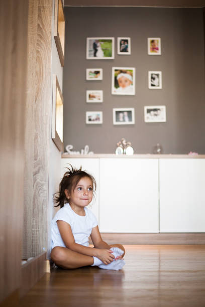 istock cute little girl playing on floor 1055700430