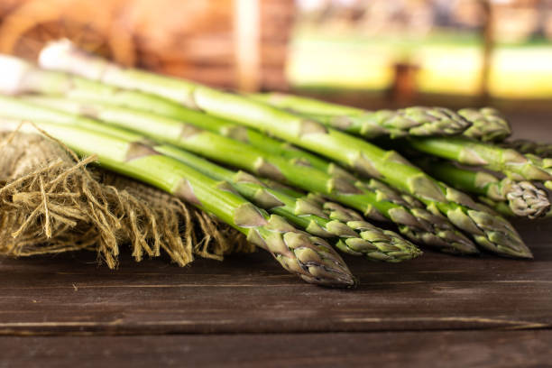 istock Fresh green asparagus spear on brown wood 1055703488