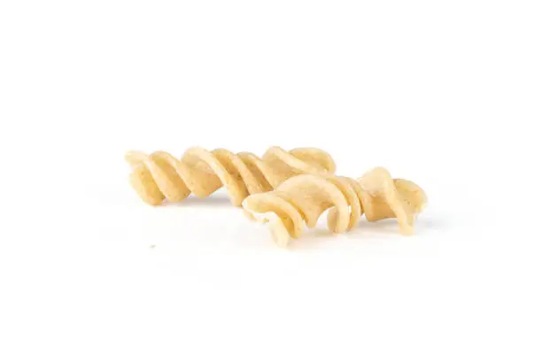 Group of two whole twisted raw pasta fusilli variety isolated on white background