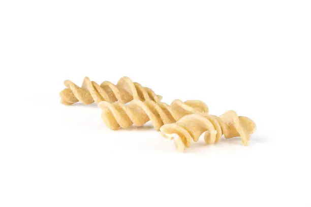 Set of three whole raw pasta fusilli variety isolated on white background