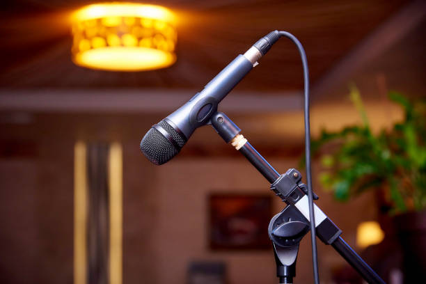istock Microphone on the rack close-up on a blurred background. 1055705790