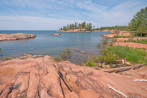 istock Worn Granite Rocks on a Wilderness Lakeshore 1055709126