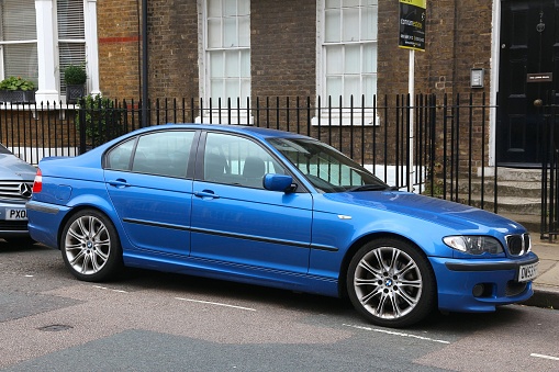 London: BMW 3 compact sedan car (series E46) parked in London, UK. BMW manufactured  2,512,635 vehicles in 2016.