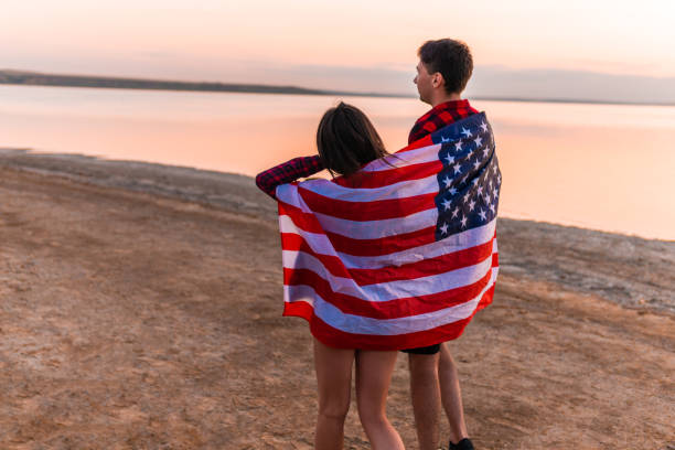 istock oung couple on the beach walking together 1055711232