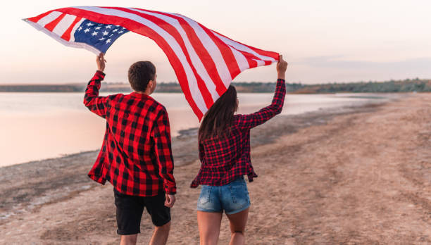 istock oung couple on the beach walking together 1055711280