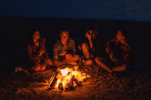 istock young friends have picnic with bonfire on the beach 1055711470