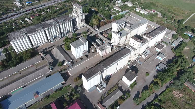 Grain terminal. The old Soviet grain elevator. Top view of a silo elevator. Aerophotographing industrial object.